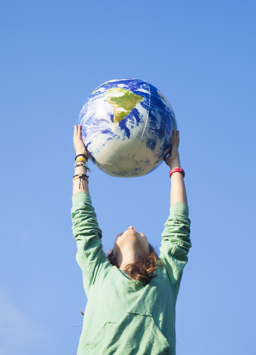 A Clean Coast Crew Volunteer Holding Up a Globe To Signify Our Worldwide Reach And Mission