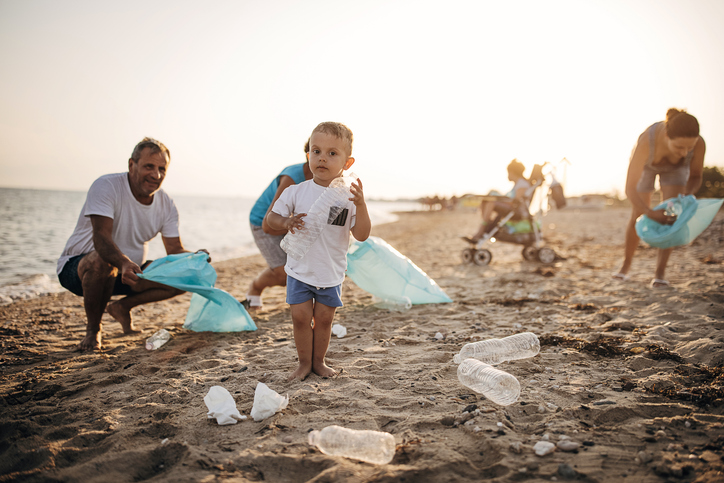 A young family with children participates in a local beach cleanup event with Clean Coast Crew